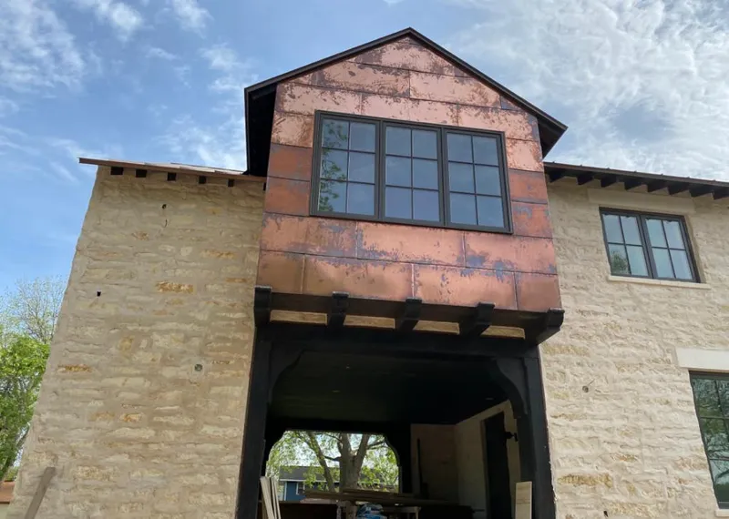 Copper metal panel facade on a stone building for Metal Roof Coating in Mack